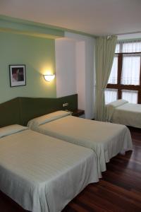 Postel nebo postele na pokoji v ubytování Hotel Sindika
