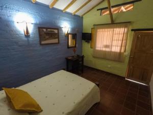 Postel nebo postele na pokoji v ubytování Finca Hotel La Quinta Porra