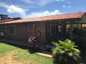 a small brown house with a red roof at Pousada do Bita in Fernando de Noronha