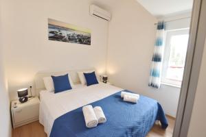 Postel nebo postele na pokoji v ubytování Apartments Lorena