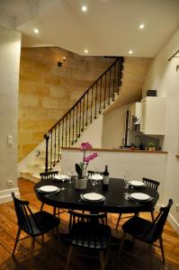 a dining room with a black table and chairs at Romance au coeur de Bordeaux / Jardin Public in Bordeaux +51 photos