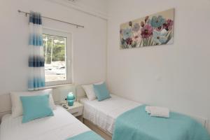 Postel nebo postele na pokoji v ubytování Apartments Lorena