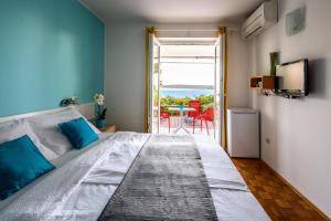 a bedroom with a bed and a view of the ocean at Apartments & Rooms Matos in Portorož