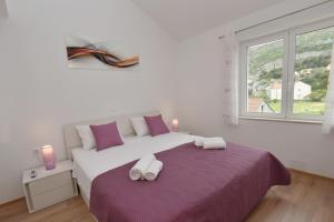 Postel nebo postele na pokoji v ubytování Apartments Lorena