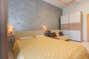 a bedroom with a large bed and a chair at Studio Apartment Leana in Labin