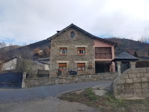 a stone house on the side of a road at Casa Rural Calecha in Caboalles de Abajo