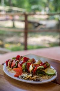 a plate of food with vegetables on a table at Cabañas Kin Balam Palenque in Palenque +72 photos