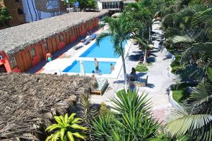 an overhead view of a resort pool with people in it at Selina Montañita in Montañita