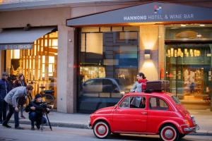 
a red car parked in front of a store at HANNONG Hotel & Wine Bar in Strasbourg

