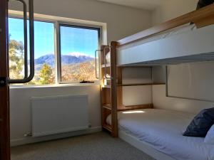 a bedroom with bunk beds and a large window at The Shed House in Mount Beauty +30 photos