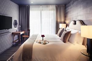 ein Hotelzimmer mit einem großen Bett und einem Schreibtisch in der Unterkunft Mathias Luxury Plus by Viadora in Mexiko-Stadt