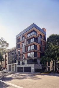 a tall building with a car parked in front of it at Mathias Luxury Plus by Viadora in Mexico City