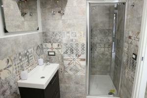 uma casa de banho com um chuveiro, um lavatório e uma banheira em Antica Civita em Catânia