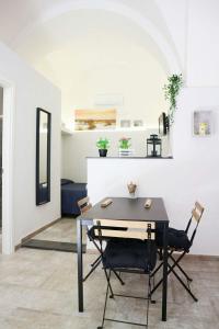 a dining room with a black table and chairs at Antica Civita in Catania