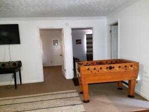 a room with a foosball table in the middle of a room at KY Lake Area Cabin in Aurora