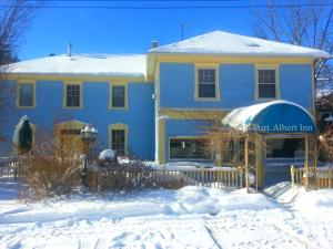 a blue house in the snow with a fence at 2 bedroom Wiffen Cottage in Port Albert