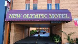 a new olympic motel sign on the front of a building at New Olympic Motel in Lismore