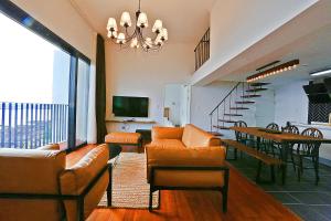 ein Wohnzimmer mit Sofas und ein Esszimmer in der Unterkunft The Villas Ocean for Family in Seogwipo