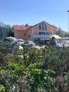 a large building with rocks in front of it at Shania Residence in Übersee