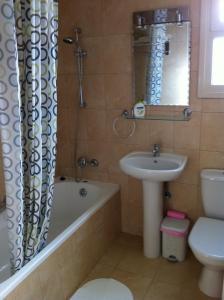 a bathroom with a sink and a tub and a toilet at Sunny Garden Limassol Star in Limassol