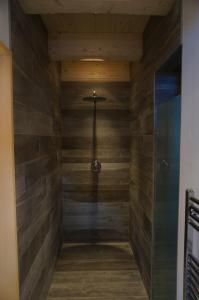 a walk in shower with wooden walls and a glass door at Ski Chalet Nomad in Maria Alm am Steinernen Meer
