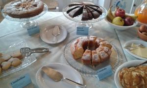 a display of different types of cakes and other desserts at Agriturismo Is Solinas in Masainas