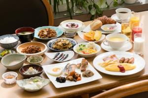 a table with many plates of food on it at Ark Hotel Okayama -ROUTE INN HOTELS- in Okayama