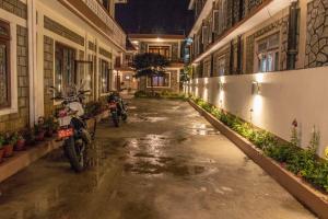 an alley with motorcycles parked in a building at Hotel Cordial in Pokhara