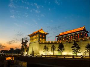 a building with a clock tower next to a bridge at Grand Hyatt Xi'an in Xi'an