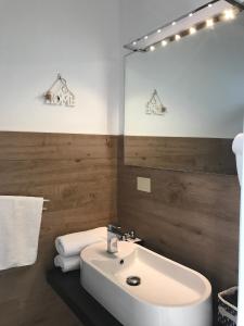 a bathroom with a white sink and a mirror at Le Fiche d’India in Giuggianello +66 photos