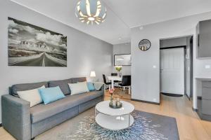 a living room with a couch and a table at Forenom Serviced Apartments Oslo Rosenhoff in Oslo