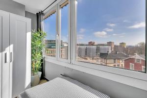 a bedroom with a bed and a large window at Forenom Serviced Apartments Oslo Rosenhoff in Oslo