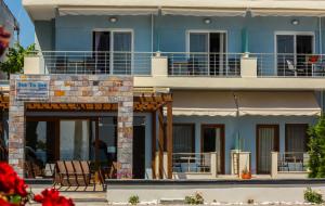 a blue building with a balcony on top of it at Sea to See in Nea Peramos