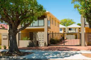 a house with a fence and a tree in front of it at Midland Haven - Midland WA in Midland Junction