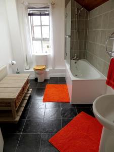 a bathroom with a tub and a toilet and a sink at Hidden Treasure set within a 1900's Pumping Station in London