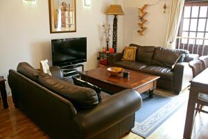 a living room with leather couches and a coffee table at Hidden Treasure set within a 1900's Pumping Station in London