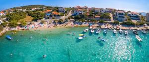 an aerial view of a beach with boats in the water at Lubin in Sevid