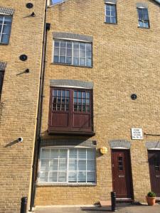 a brick building with a balcony on the side of it at Hidden Treasure set within a 1900's Pumping Station in London