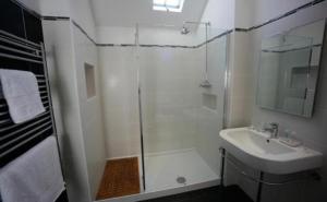a bathroom with a shower, sink, and toilet at The Staff Of Life in Ticknall