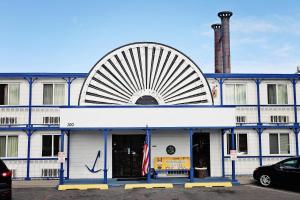 a blue and white building with a fan on the top at National 9 Inn Showboat in Casper