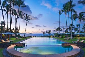 a large swimming pool with palm trees and palm trees at Hana-Maui Resort, a Destination by Hyatt Residence in Hana