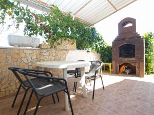 a patio with a table and chairs and a pizza oven at Apartments Hasiba 1362 in Peroj