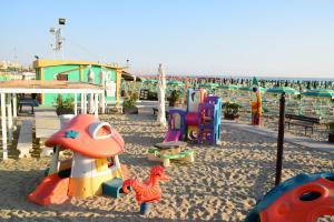 a playground on the beach with many different types of play equipment at Hotel Houston in Rimini
