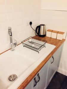 a kitchen counter with a tea kettle on it at Kenilworth Cosy Garden View Apartment in Kenilworth