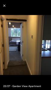 a hallway leading to a room with a bedroom at Kenilworth Cosy Garden View Apartment in Kenilworth