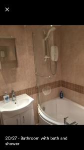 a bathroom with a shower with a toilet and a sink at Kenilworth Cosy Garden View Apartment in Kenilworth