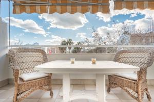 a white table and chairs on a balcony with a window at Apartamento Azul in Marbella