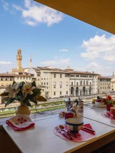 a table with a view of a city from a balcony at Ponte Vecchio Terrace in Florence