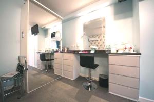 a bathroom with a counter and a sink and a mirror at Talybont B&B Aberystwyth in Talybont