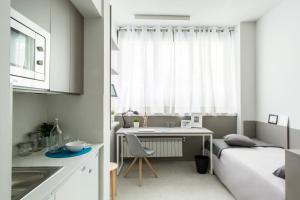 a small kitchen with a bed and a desk in a room at Residencia Universitaria Claudio Coello in Madrid
